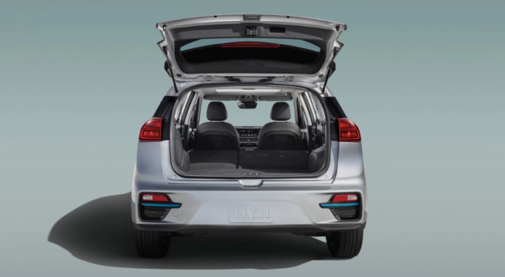 A white 202 Kia Niro EV is shown from the back with an open lift gate.
