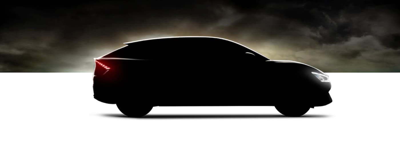 A 2022 Kia EV6 is shown from the side, in silhouette, with its headlights and taillights illuminated. 
